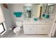Bathroom featuring a white vanity, toilet, decorative accents and shower with glass doors at 13100 Fish Cove Dr, Spring Hill, FL 34609