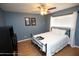 Cozy bedroom with wood floors, a ceiling fan, and natural light from the window at 13100 Fish Cove Dr, Spring Hill, FL 34609