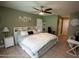 Bedroom with green walls, ceiling fan, a bed with white and green covers and tile floors at 13100 Fish Cove Dr, Spring Hill, FL 34609