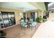 A covered patio with a table and seating next to a pool at 13100 Fish Cove Dr, Spring Hill, FL 34609