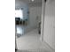Bright foyer featuring tile flooring, neutral walls, and seamless flow into the living room at 13100 Fish Cove Dr, Spring Hill, FL 34609