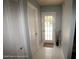 Hallway with tile flooring, closet and a door with window panes providing natural light at 13100 Fish Cove Dr, Spring Hill, FL 34609