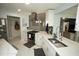 Bright kitchen featuring stainless steel appliances, sleek countertops and modern lighting at 13100 Fish Cove Dr, Spring Hill, FL 34609