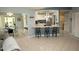 Open-concept living space featuring a breakfast bar, tile floors, recessed lights, and modern appliances at 13100 Fish Cove Dr, Spring Hill, FL 34609