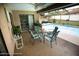 Inviting screened-in patio with a table and chairs overlooking a sparkling pool and well-maintained yard at 13100 Fish Cove Dr, Spring Hill, FL 34609