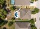 Expansive aerial view of a home with a private pool, patio, and fire pit in a fenced backyard at 18331 Waydale Loop, Hudson, FL 34667