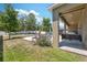 Lush backyard featuring a covered patio with a swing, pool, and green space for outdoor activities at 18331 Waydale Loop, Hudson, FL 34667