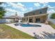 Inviting backyard with a private pool, patio area, lush lawn, and mature trees, ideal for outdoor enjoyment at 18331 Waydale Loop, Hudson, FL 34667