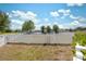 Backyard with a classic white picket fence, offering privacy and charm to the outdoor space at 18331 Waydale Loop, Hudson, FL 34667