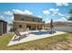 Expansive backyard with a sparkling pool, covered patio, and ample space for recreation and leisure at 18331 Waydale Loop, Hudson, FL 34667