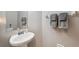 Clean bathroom with a pedestal sink, neutral walls, and decorative towels at 18331 Waydale Loop, Hudson, FL 34667