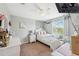 Bright bedroom features a window view, decor accents, and a cozy white chair at 18331 Waydale Loop, Hudson, FL 34667