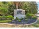 Stone community sign that reads 'Briar Oaks' surrounded by lush landscaping at 18331 Waydale Loop, Hudson, FL 34667