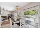 Bright dining area with a view of the pool and adjacent living room at 18331 Waydale Loop, Hudson, FL 34667