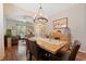 Bright dining area with a wooden table and a view of the living room at 18331 Waydale Loop, Hudson, FL 34667