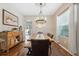 Bright dining room with a wooden table, chandelier, and a view of the backyard at 18331 Waydale Loop, Hudson, FL 34667