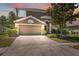 Charming two-story home with a well-manicured lawn, mature landscaping, and a two-car garage at 18331 Waydale Loop, Hudson, FL 34667