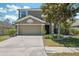 Charming two-story home with a well-manicured lawn, mature landscaping, and a two-car garage at 18331 Waydale Loop, Hudson, FL 34667