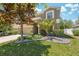 Beautiful two-story house featuring a well-manicured lawn and garden beds with decorative rocks at 18331 Waydale Loop, Hudson, FL 34667