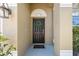 Close-up of a black front door with a wreath, sidelights, and a welcoming mat at 18331 Waydale Loop, Hudson, FL 34667