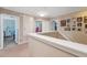 Upstairs hallway features neutral colors and access to bedrooms at 18331 Waydale Loop, Hudson, FL 34667
