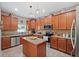 Well-lit kitchen with stainless steel appliances, granite countertops, and island at 18331 Waydale Loop, Hudson, FL 34667