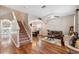 Open-concept living space with hardwood floors, archways, a staircase, and a dining area at 18331 Waydale Loop, Hudson, FL 34667