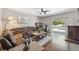 Comfortable living room featuring a sectional sofa, hardwood floors, and natural light at 18331 Waydale Loop, Hudson, FL 34667
