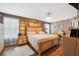 Spacious main bedroom features wood floors and a decorative ceiling fan at 18331 Waydale Loop, Hudson, FL 34667