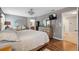 Main bedroom with wood floors, a ceiling fan, and an ensuite bathroom at 18331 Waydale Loop, Hudson, FL 34667