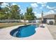 Relaxing backyard featuring a pristine blue pool surrounded by well-maintained landscaping and patio furniture at 18331 Waydale Loop, Hudson, FL 34667