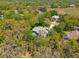 Aerial view of home with a pool surrounded by verdant trees and a serene natural landscape in a gated community at 18663 Autumn Lake Blvd, Hudson, FL 34667