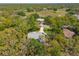Expansive aerial view of a home surrounded by lush greenery, offering privacy and a serene setting in a gated community at 18663 Autumn Lake Blvd, Hudson, FL 34667