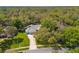 An aerial view of a home nestled among lush trees in a well-wooded neighborhood at 18663 Autumn Lake Blvd, Hudson, FL 34667