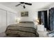 Bedroom featuring a ceiling fan, closet, and bedside table with lamps at 18663 Autumn Lake Blvd, Hudson, FL 34667