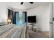 Bedroom with view of pool through window, and desk with TV at 18663 Autumn Lake Blvd, Hudson, FL 34667