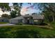 Charming single-story home with a well-manicured lawn, mature landscaping, and inviting curb appeal, with a side entry garage at 18663 Autumn Lake Blvd, Hudson, FL 34667