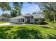 Charming single-story home with lush green lawn and mature trees in a peaceful setting at 18663 Autumn Lake Blvd, Hudson, FL 34667