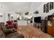 Open-concept living room featuring tile floors, a breakfast bar, and a view of the modern kitchen at 18663 Autumn Lake Blvd, Hudson, FL 34667