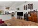 Bright living room featuring tile floors, a breakfast bar, and a view of the stainless steel kitchen appliances at 18663 Autumn Lake Blvd, Hudson, FL 34667