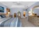 The main bedroom boasts neutral carpet, tray ceiling with fan, and ensuite bath with vanity at 18663 Autumn Lake Blvd, Hudson, FL 34667