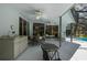 Covered patio with ceiling fans, sliding glass doors, and an outdoor dining area at 18663 Autumn Lake Blvd, Hudson, FL 34667
