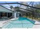 A sunlit, screened-in pool with a spacious deck and access to the home's interior at 18663 Autumn Lake Blvd, Hudson, FL 34667