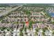 Aerial view of the home surrounded by a residential community, trees, and a highway in the distance at 2431 Murray Pass, Odessa, FL 33556