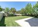 Lush backyard with green lawn, paved patio area, and privacy landscaping at 2431 Murray Pass, Odessa, FL 33556