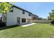 View of backyard featuring lush green grass, patio area, and the home's exterior at 2431 Murray Pass, Odessa, FL 33556