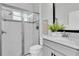 Bright bathroom featuring a glass-enclosed shower and a modern vanity with a marble countertop at 2431 Murray Pass, Odessa, FL 33556