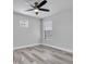 Bright bedroom featuring wood-look flooring, a modern ceiling fan, and lots of natural light at 2431 Murray Pass, Odessa, FL 33556