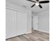 Bright bedroom featuring wood-look flooring, closet, and white painted walls at 2431 Murray Pass, Odessa, FL 33556