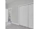 Carpeted bedroom with a walk-in closet and open doorway at 2431 Murray Pass, Odessa, FL 33556